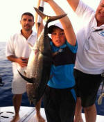 Young man catches tuna on fishing trip in Cyprus.