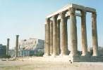 Temple of Olympian Zeus with the view of the Parthenon in the background. The Olympian Temple was the largest temple ever built in Greece. Today only 15 columns remain standing, Click on this photograth for a larger view